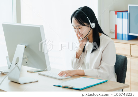 Young woman working in a call center Young woman working in a call center 106748223