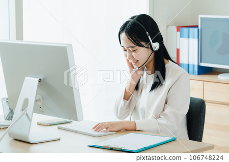 Young woman working in a call center Young woman working in a call center 106748224