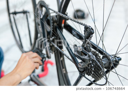 Close up of mans hands reparing bike transmission system 106748664