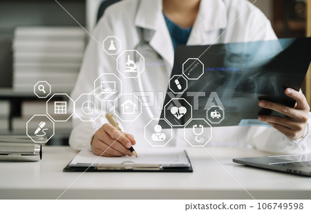 doctor working on digital tablet healthcare doctor technology tablet using x-ray film analyzed the results of medical reports. doctor working on digital tablet healthcare doctor technology tablet using x-ray film analyzed the results of medical reports. 106749598