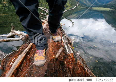 Hiking on a one plank bridge in high altitude mountains Hiking on a one plank bridge in high altitude mountains 106750078