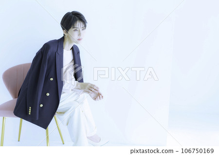 Fashion portrait of a young woman wearing a jacket against a white background 106750169