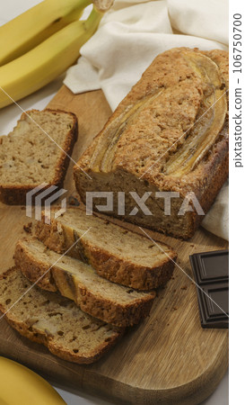 fresh banana bread lies on a gray background close-up fresh banana bread lies on a gray background close-up 106750700