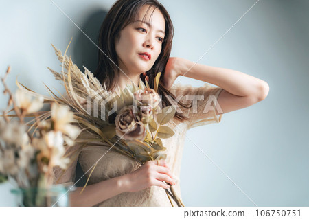 Portrait of a middle-aged woman holding dried flowers Beauty Skin Care Portrait of a middle-aged woman holding dried flowers Beauty Skin Care 106750751