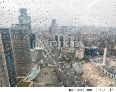 Istanbul Levent financial district with skyscrapers and traffic on a rainy day as seen behind a wet window with raindrops Istanbul Levent financial district with skyscrapers and traffic on a rainy day as seen behind a wet window with raindrops 106750917