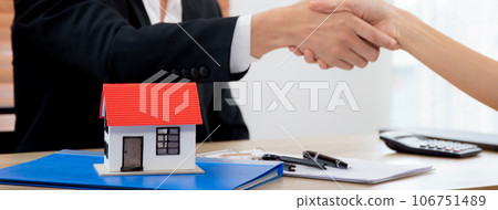Closeup hands of real estate agent and customer handshake together after agreement together. 106751489