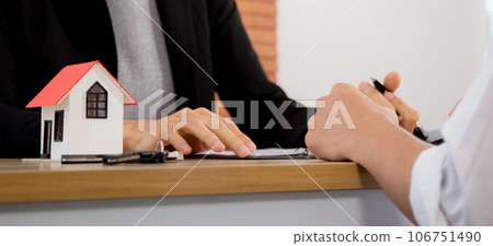 Young man customer talking with agent about contract buying house and agreement of mortgage. 106751490