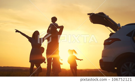 family by car resting in the park. family and children silhouette resting on the car playing ball at sunset in the park on vacation. happy family kid dream concept. camping by sun car in the park 106752121