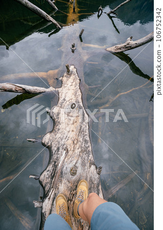 Hiking on a one plank bridge in high altitude lake 106752342