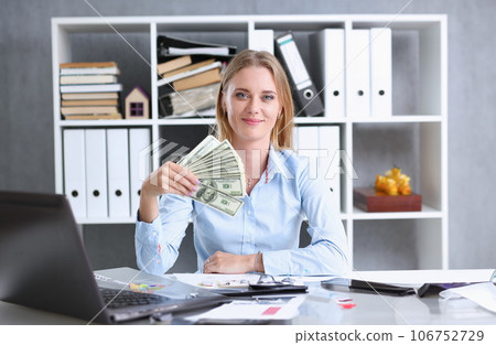 Beautiful businesswoman portrait. Scattering money 106752729