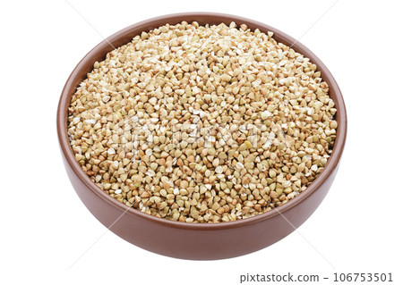 Unroasted buckwheat in a bowl. Useful dietary product. Isolated on a white background. 106753501