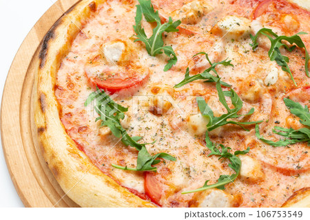 Fresh Italian pizza with arugula and cheese, close-up. Isolated on white background. Fresh Italian pizza with arugula and cheese, close-up. Isolated on white background. 106753549