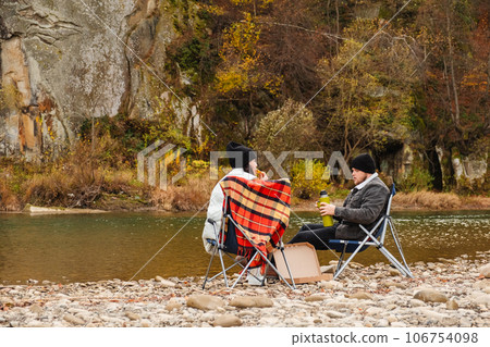 happy couple having picnic at river beach 106754098