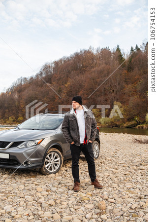 man near car at mountain river beach man near car at mountain river beach 106754153