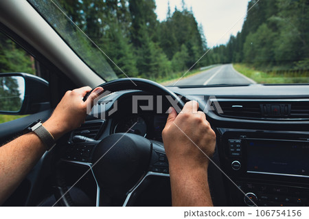 man hands on steering wheel 106754156