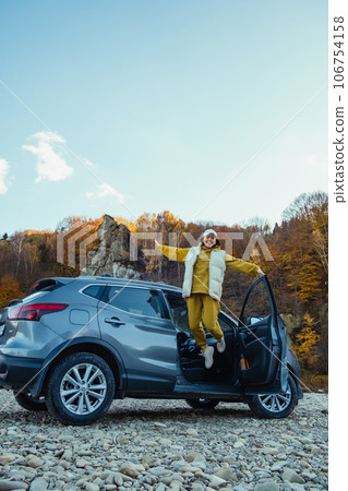happy woman car traveler at rocky river beach 106754158