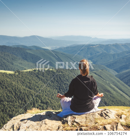 Young woman on the top of mountain 106754274
