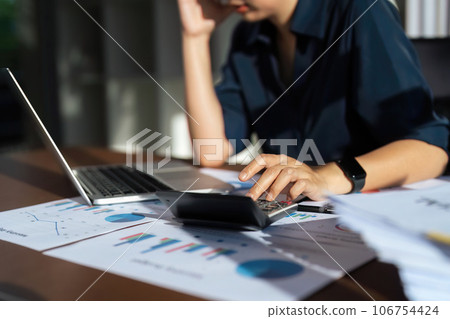 Close up of businessperson analysis and calculate chart and graph showing change and growth on the finance and marketing 106754424