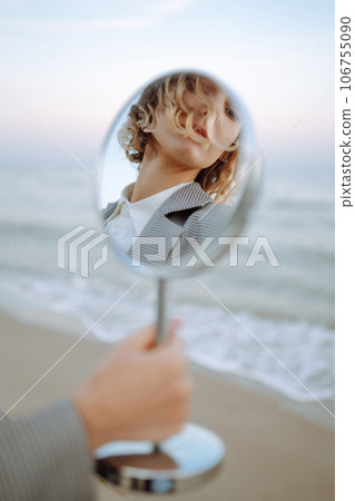 Fashion Model posing near the sea. Young woman resting in nature. People, lifestyle, relaxation. 106755090