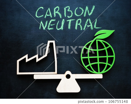 Symbolic scales with an industrial plant and green planet. Carbon neutral concept. 106755148