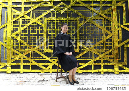 College graduate sitting in front of golden background at university Bangkok Thailand College graduate sitting in front of golden background at university Bangkok Thailand 106755685