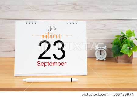The Hello autumn on 23rd September 2023 desk calendar and pen on wooden table. The Hello autumn on 23rd September 2023 desk calendar and pen on wooden table. 106756974