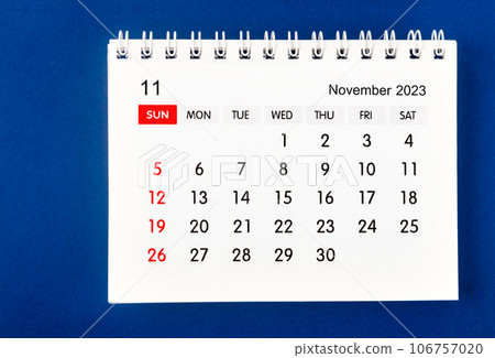 The November 2023 Monthly desk calendar for 2023 year on dark blue background. 106757020