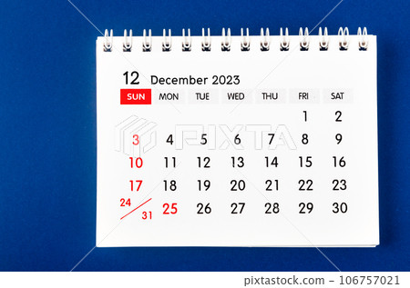 The December 2023 Monthly desk calendar for 2023 year on dark blue background. 106757021