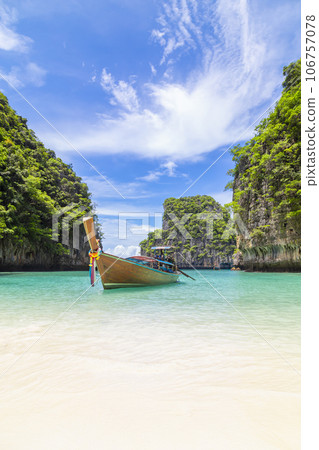Thai traditional wooden longtail boat and beautiful beach in Phuket province, Thailand. 106757078