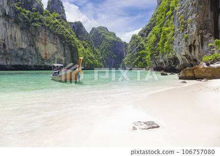 The Thai traditional wooden longtail boat and beautiful beach in Phuket province, Thailand. 106757080