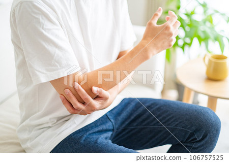 Man with arm/elbow pain Man with arm/elbow pain 106757525