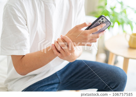 一名男子拿著智能手機,手腕疼痛 一名男子拿著智能手機,手腕疼痛 106757585