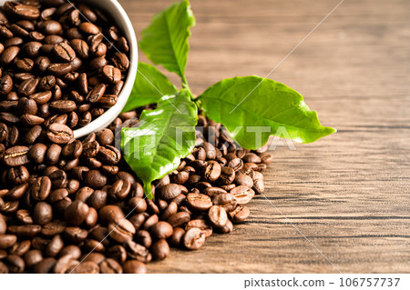 Coffee brown bean medium roasted with fresh green leaf. 106757737
