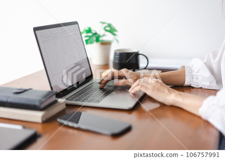 Businesswomen typing data on keyboard of laptop and working about new startup in outside office 106757991