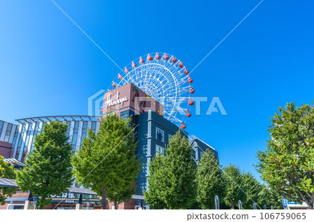 Yokohama cityscape, Japan, summer. In front of Center Kita Station, view of the cityscape including the Ferris wheel and Tsuzuki Hankyu against the blue sky = August Yokohama cityscape, Japan, summer. In front of Center Kita Station, view of the cityscape including the Ferris wheel and Tsuzuki Hankyu against the blue sky = August 106759065