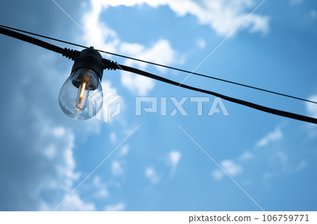Light bulb and blue sky background Light bulb and blue sky background 106759771