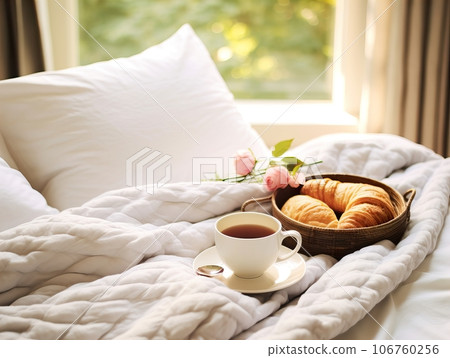 Beautiful cozy breakfast in bed, home bedroom interior with bright morning light, healthy food on decorated tray, weekend meal Beautiful cozy breakfast in bed, home bedroom interior with bright morning light, healthy food on decorated tray, weekend meal 106760256
