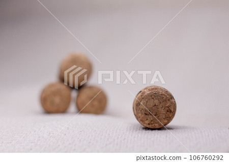 four wine corks with a pyramid on a light background. 106760292
