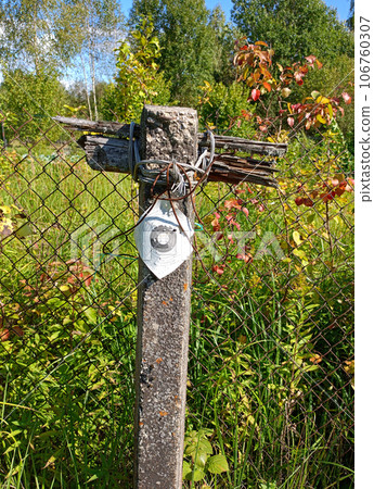 A fence post with a target printed on paper for sport shooting 106760307
