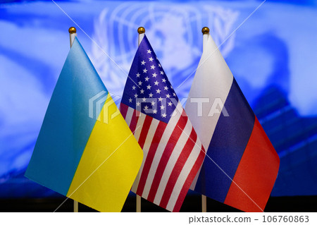The US flag, Russian flag, Ukraine flag. Flag of USA, flag of Russia, flag of Ukraine. The United States of America and the Russian Federation confrontation. Russia invasion of Ukraine. Close-up 106760863