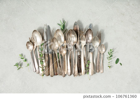 Rustic vintage cutlery on grey stone background flat lay Rustic vintage cutlery on grey stone background flat lay 106761360