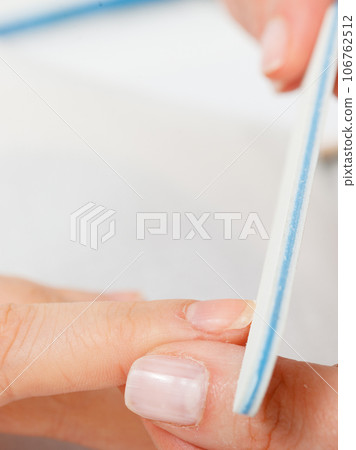 Preparing nails before manicure, beautician file nails 106762512
