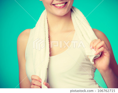 Woman with a towel around her shoulders smiling Woman with a towel around her shoulders smiling 106762715
