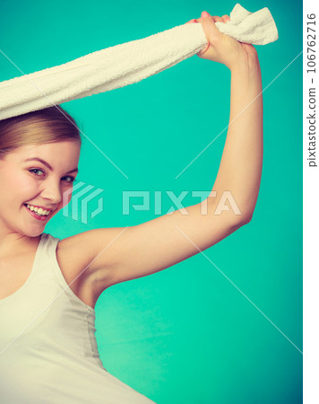 Woman with a towel above her head Woman with a towel above her head 106762716