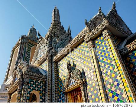 Hor Phra Gandhararat chapel building exterior details with mosaic tiles by Wat Phra Kaew temple of Grand Palace complex in Bangkok, Thailand Hor Phra Gandhararat chapel building exterior details with mosaic tiles by Wat Phra Kaew temple of Grand Palace complex in Bangkok, Thailand 106762872