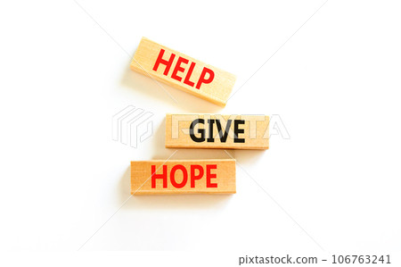 Help give hope symbol. Concept word Help give hope on beautiful wooden block. Beautiful white table white background. Business motivational help give hope concept. Copy space. Help give hope symbol. Concept word Help give hope on beautiful wooden block. Beautiful white table white background. Business motivational help give hope concept. Copy space. 106763241