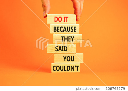 You can do it symbol. Concept words Do it because they said you could not on wooden block. Beautiful orange table background. Businessman hand. Business, motivational you can do it concept. Copy space 106763279