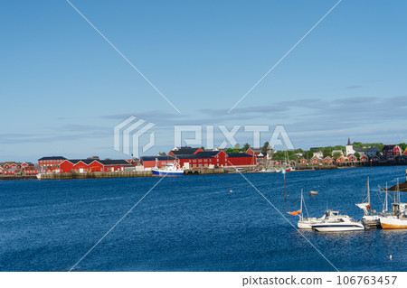 Summer in Reine, Lofoten Islands, Norway. Popular tourist destination. Old fishermans village with wooden red cottages Summer in Reine, Lofoten Islands, Norway. Popular tourist destination. Old fishermans village with wooden red cottages 106763457