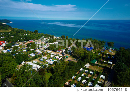 Aerial view of campsite with trailers near Baltic sea beach in Wladyslawowo, Poland. Tourists have rest during summer vacation season 106764248
