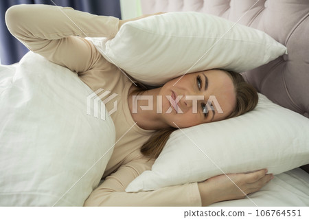 A beautiful woman can't sleep. Noisy neighbors keep you awake. Severe headache makes it difficult to sleep 106764551